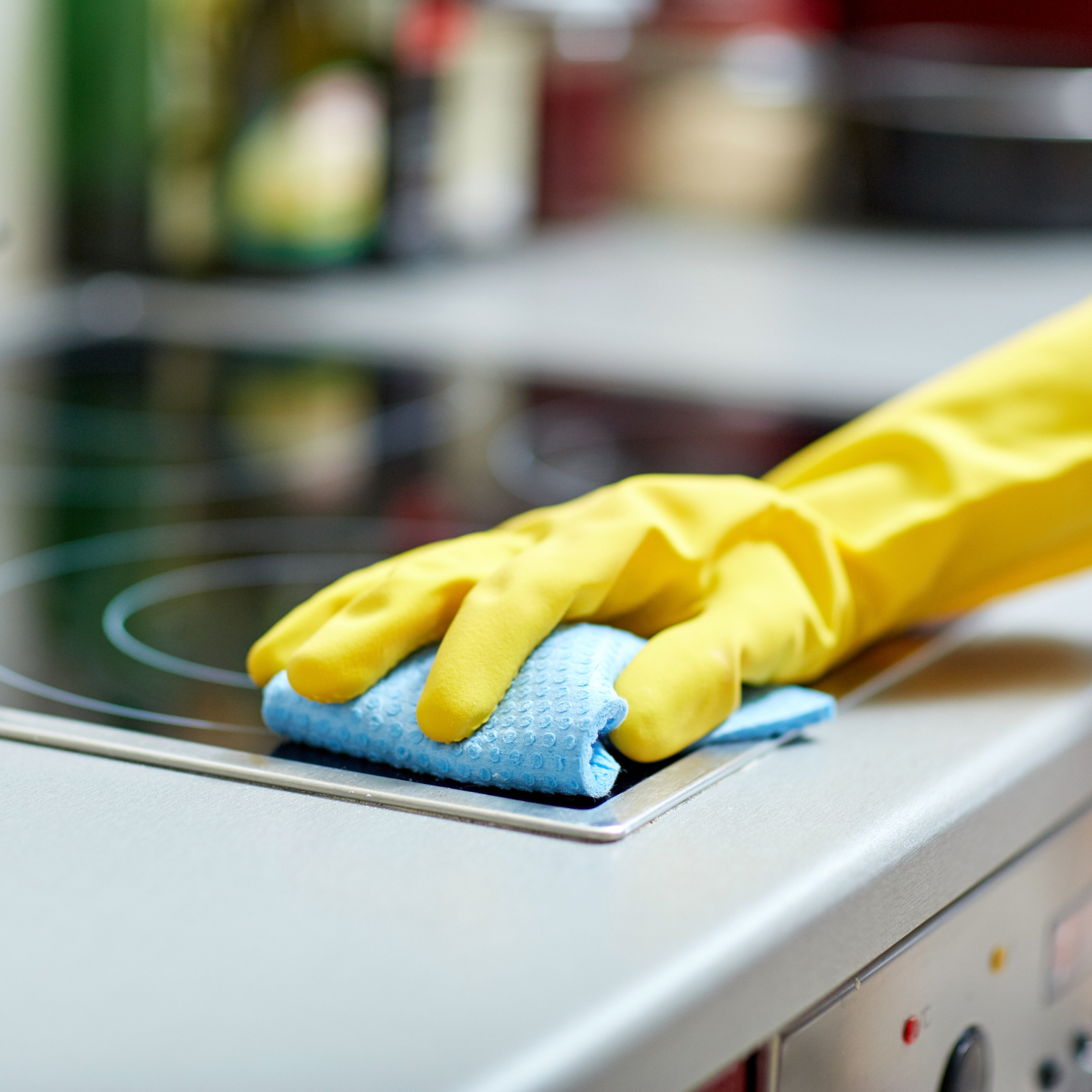 maid cleaning induction in kitchen